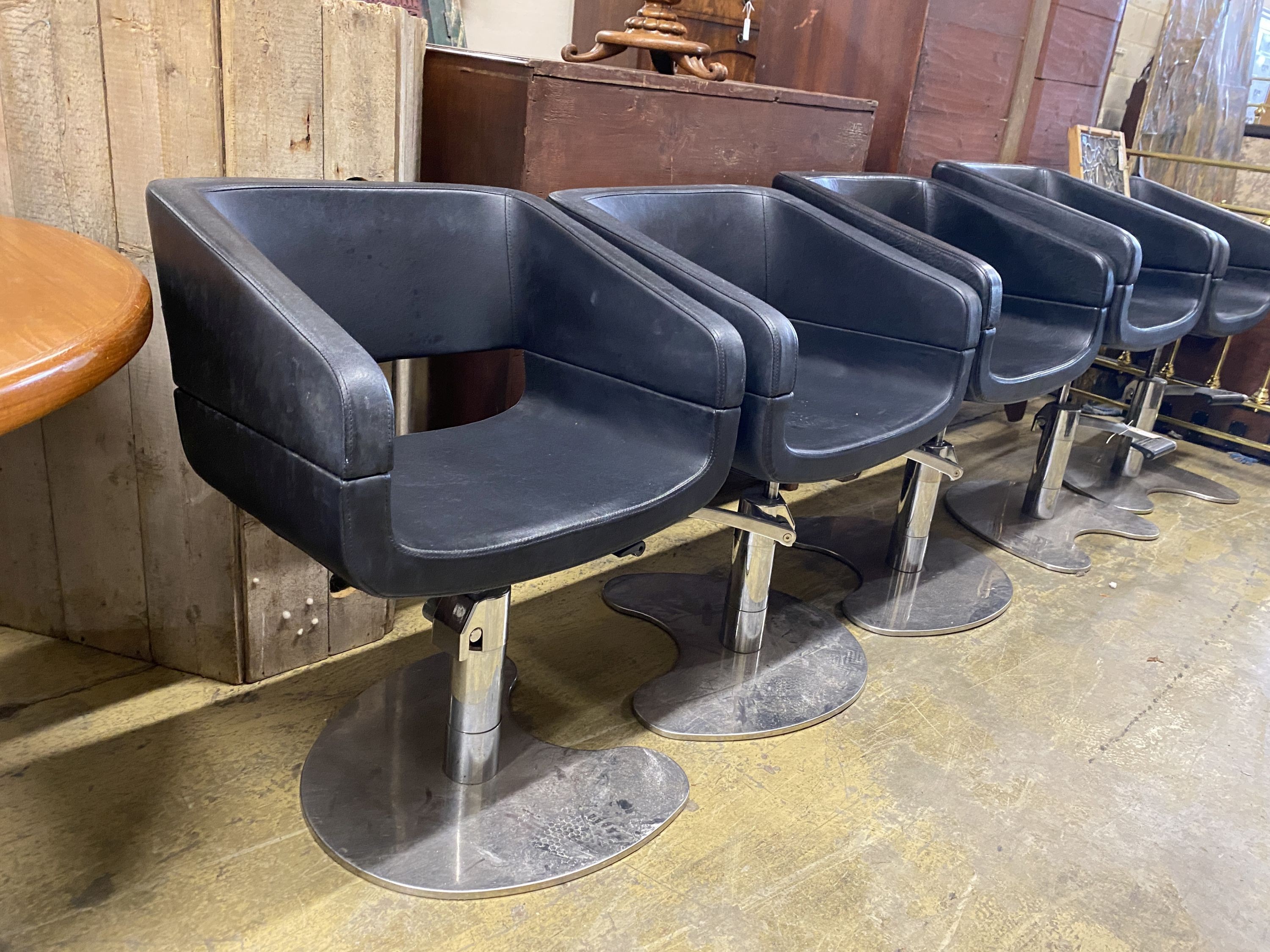 A set of five REM black leatherette and chrome hydraulic salon chairs, width 56cm, depth 42cm